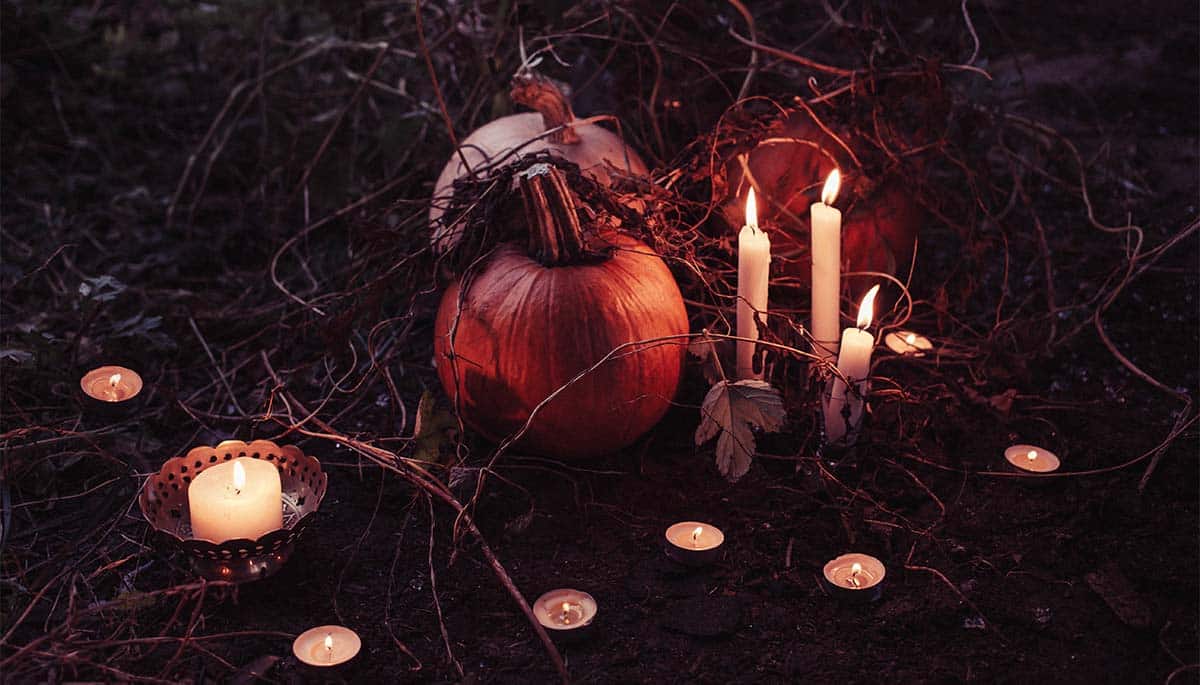 Halloween activities including lighting candles and setting out pumpkins to ward off spirits
